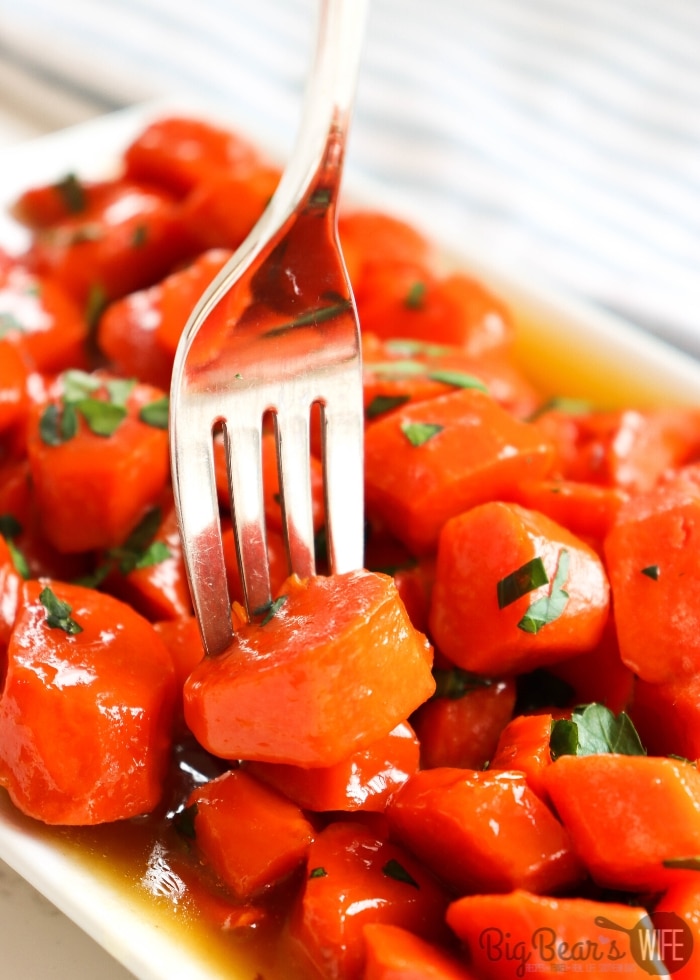Candied Carrots in with parsley on white plate with fork