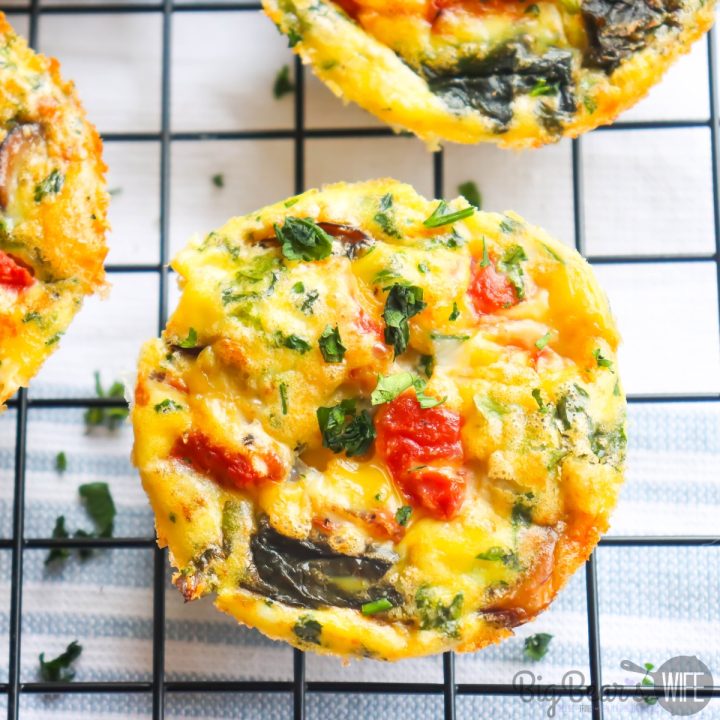 You'll love how easy this Egg Muffin Cups recipe is! Perfect for breakfast in the morning or a mid-day brunch! Fill them with anything you like! We're adding mushrooms, spinach and tomatoes to these!