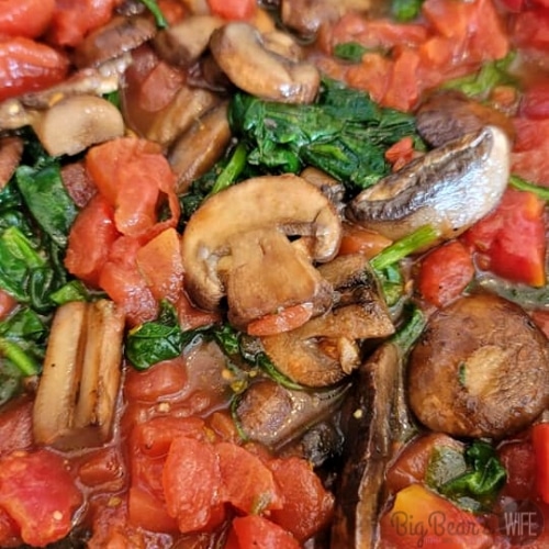 Mushrooms, diced tomatoes and spinach in a skillet (1)