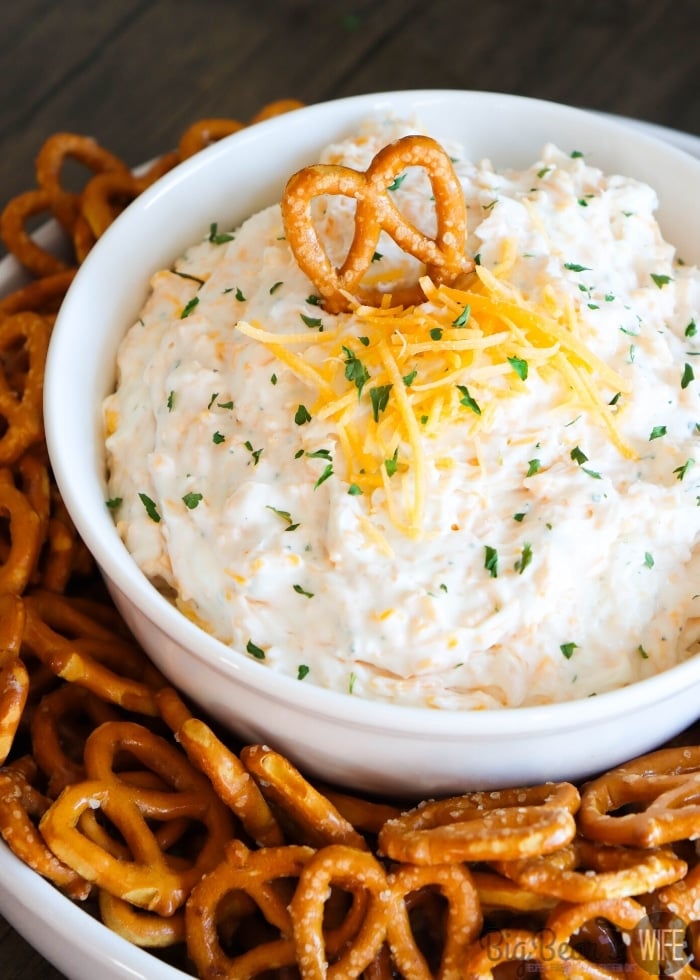Ranch Beer Cheese Dip in a white bowl, surrounded by mini pretzels