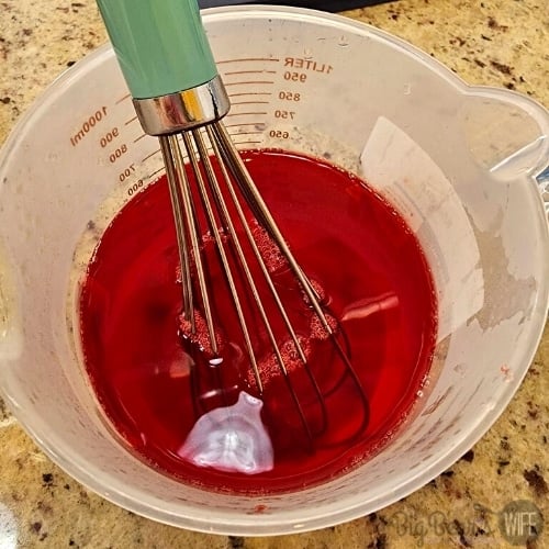 Strawberry Jell-O in measuring cup
