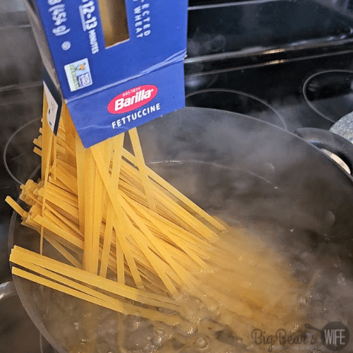 fettucine pasta going into water