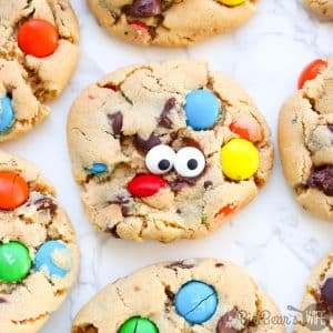 These Monster Cookies are peanut butter cookies, stuffed with chocolate chips and M&MS candies with the occasional candy eye for decoration! 