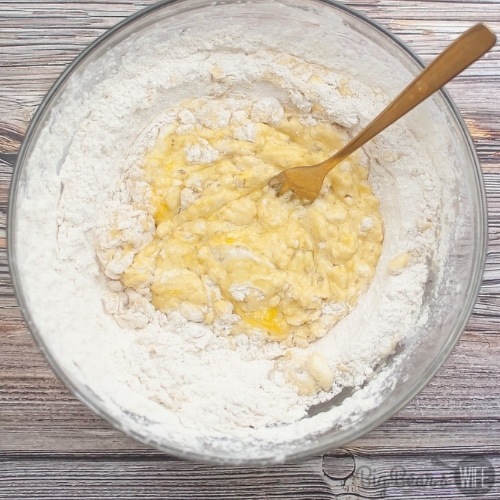 mixing eggs in flour