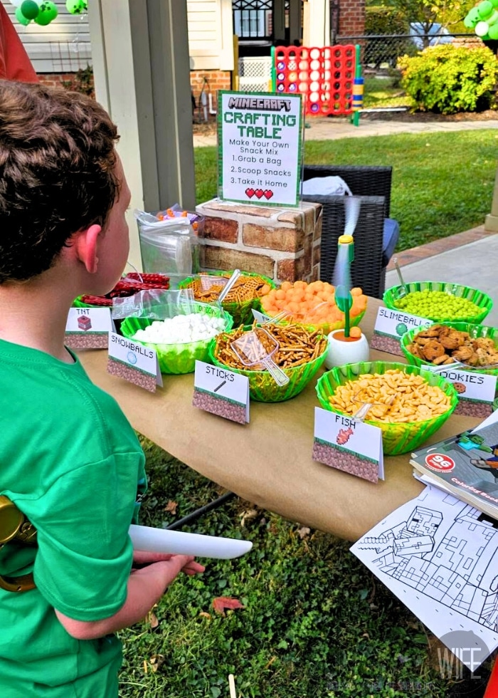 Minecraft coloring pages and activity books set up for a kids birthday party