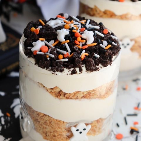 Graveyard Boo-Nana Pudding Cups decorated with ghost faces, crushed Oreo dirt, and candy bones.