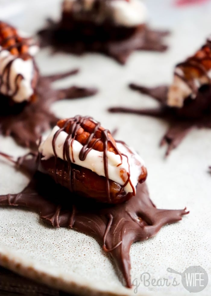 These Pecan-Stuffed Date Roaches might make you do a double take before grabbing one! Medjool dates are filled with a sweet cream cheese and pecan mixture, topped with a pecan half, and given chocolate legs and antennae for a creepy little Halloween treat.